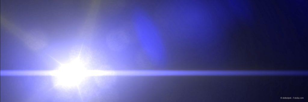 banner with a bright sun, light rays and lens flare in a dark blue sky