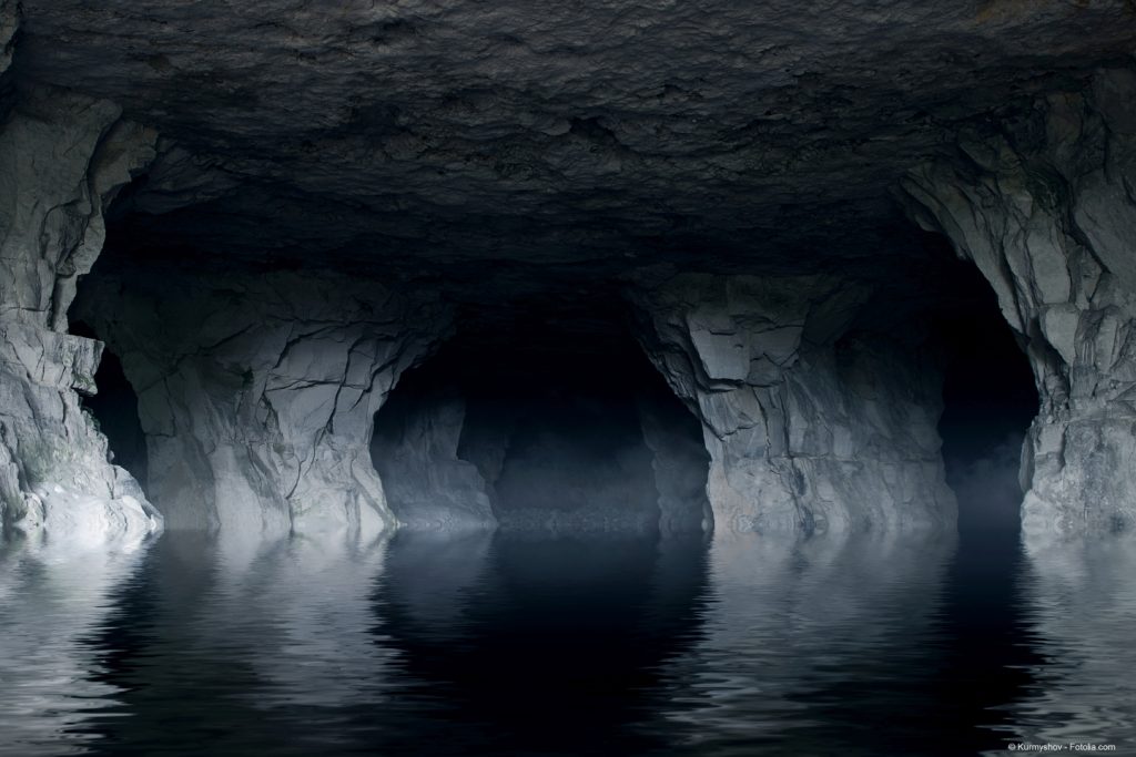 underground river in a dark stone cave